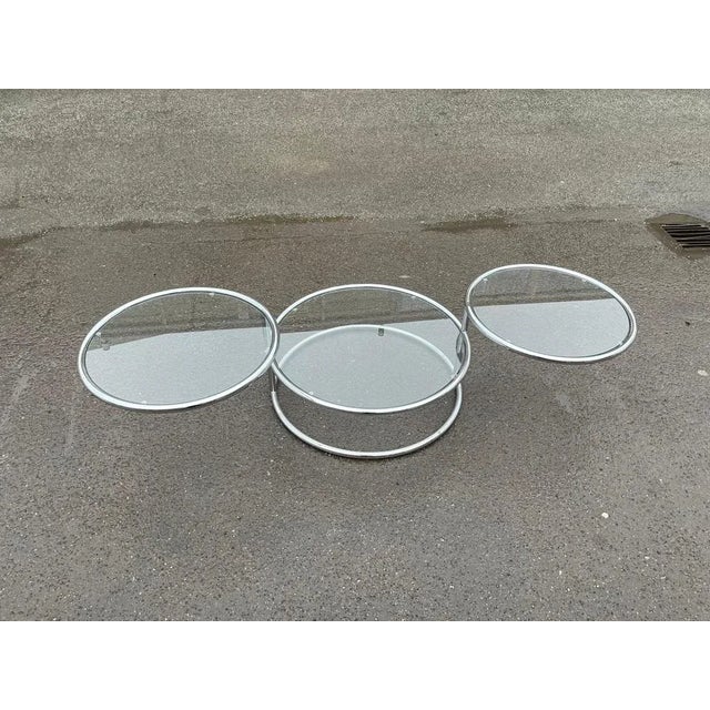 An Italian Mid-Century Modern Space Age-style 1970's, Convertible' circular cocktail / coffee table with a chrome tube...