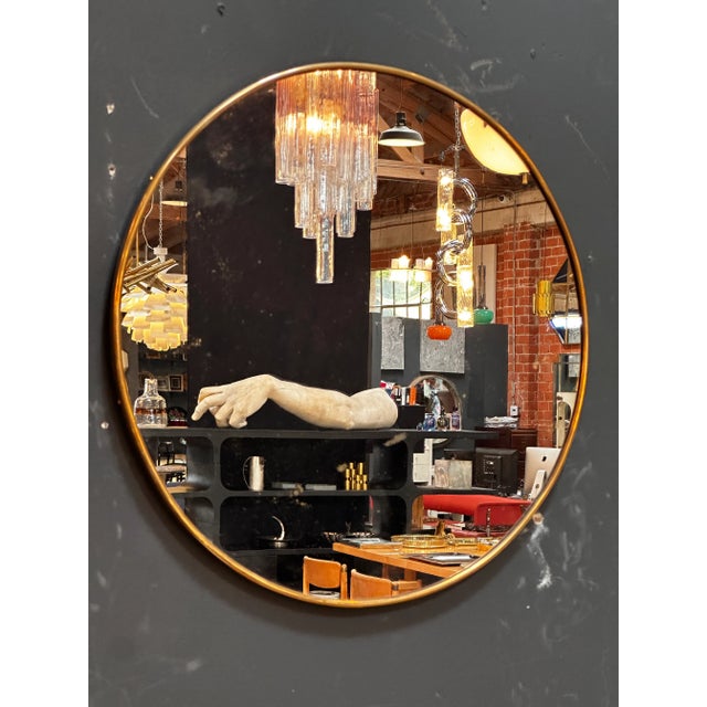 "An enchanting vintage Italian round wall mirror from the 1980s, showcasing the elegant design sensibilities of the era,...