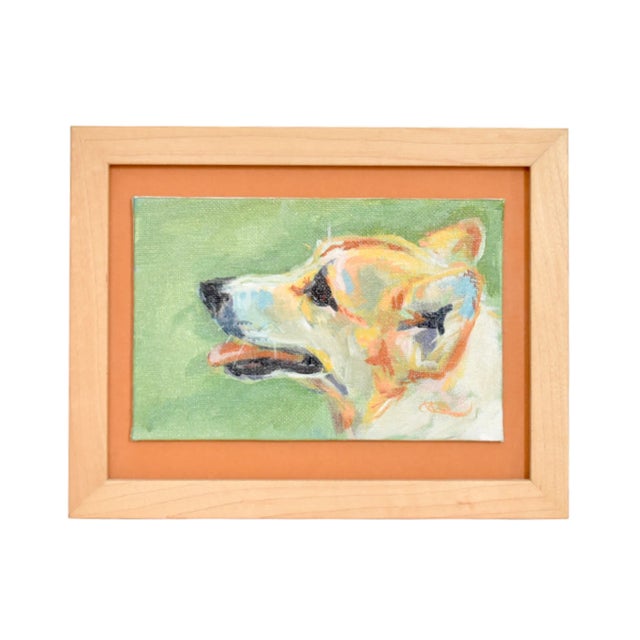A dog portrait in acrylics by artist Kimberly Kelly Santini. Framed on an orange-tan background with a blond wood frame....