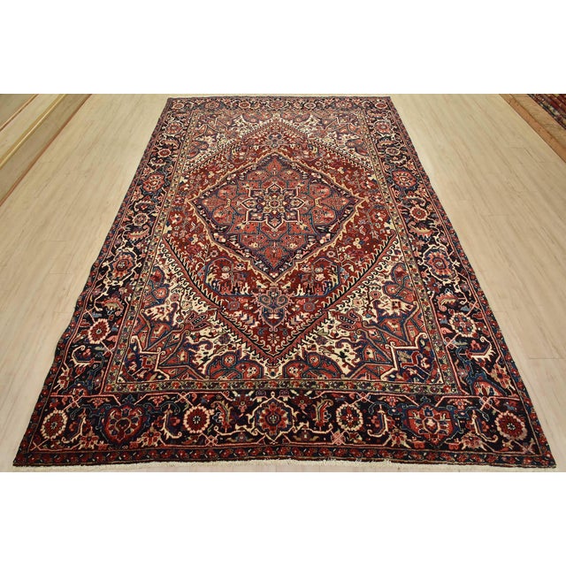 This authentic vintage traditional tribal Heriz rug is hand-knotted with fine wool and natural dyes. This beautiful...