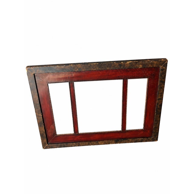 A substantial metal canvas frame featuring a generous central opening flanked by two narrower rectangular openings. A rich...