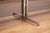 Attributed to - A heavy steel and chrome base supports an ovular laminate rosewood top that at its widest in the middle is...