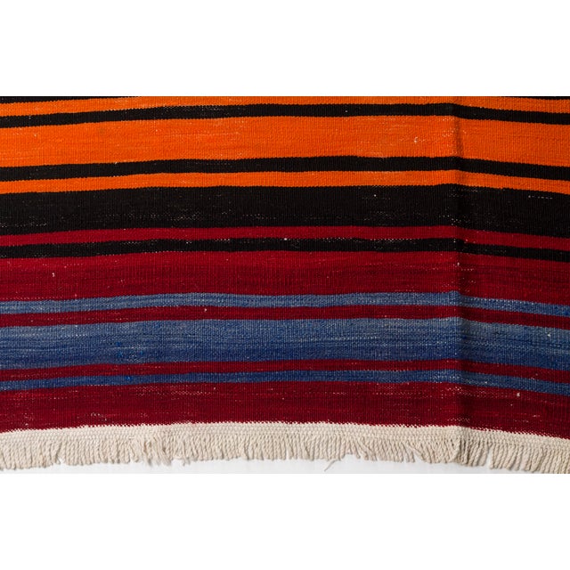 This is a vintage Turkish Oushak rug from the Mid 20th Century. The piece was hand-knotted.
