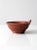 This vintage studio pottery bowl features a hand-crafted form accented by a distinctive crested swirl design. A rich...