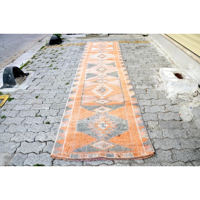 This is a vintage Turkish Oushak rug from the 1960s. The piece was hand-knotted.