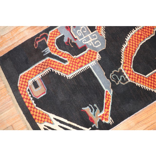 A 3rd quarter of the 20th century Tibetan rug depicting a large orange dragon. Measures: 3'2" x 5'3''.