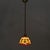 Tiffany style mini pendant single-light fixture showcases a vibrant dome shade with individual pieces of slag glass...