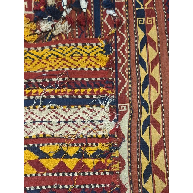 Vintage Moroccan Hanbel flat weave rug featuring striking Berber geometric motifs in rich shades of madder red, indigo,...