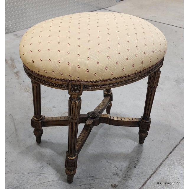 This is a very nice antique French Louis XVI style early 20th century giltwood upholstered oval shaped vanity stool or...