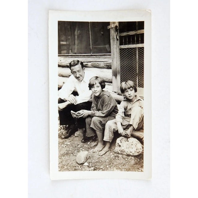 Vintage guessing circa 1930 snapshot photograph. Two barefoot girls sitting on the steps of a log cabin. Really nice...