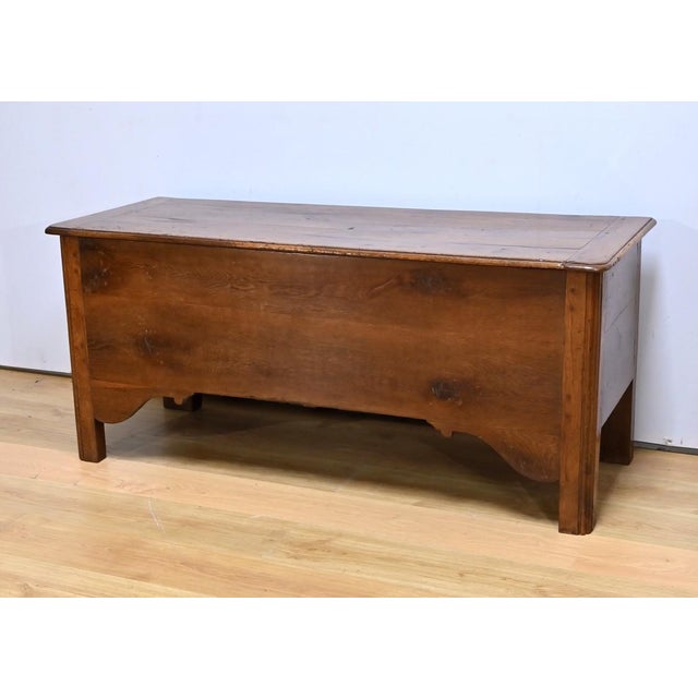 This substantial chest, made of solid oak, features a dowel-assembled structure, indicating a method of joining the...