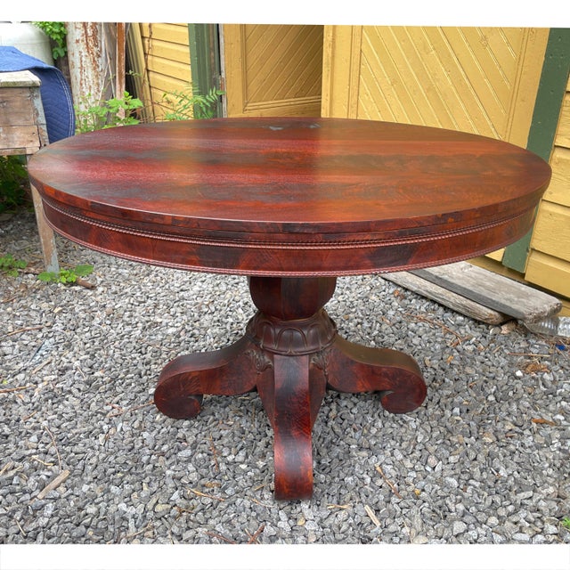 Gorgeous 1800s Empire period tavern-size table with lovely carved details and original brass casters. Gorgeous piece, will...