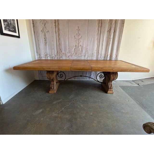 A magnificent statement of Old World craftsmanship meets monumental scale. This substantial extendable dining table...