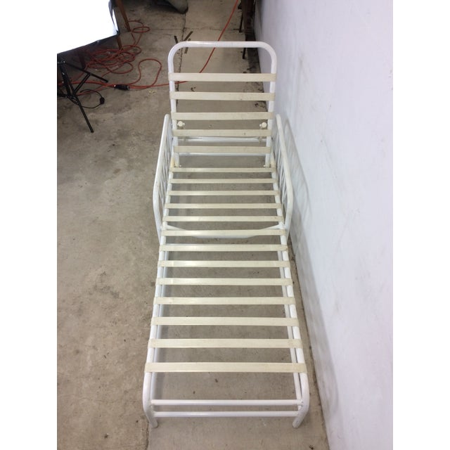 This vintage patio lounge chair features white painted aluminum frame, reclining seat back, rubberized seat supports, and...
