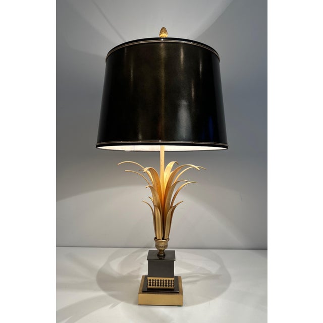 This pretty pineapple-shaped table lamp is made of black and gold lacquered metal. It is a French work in the style of...