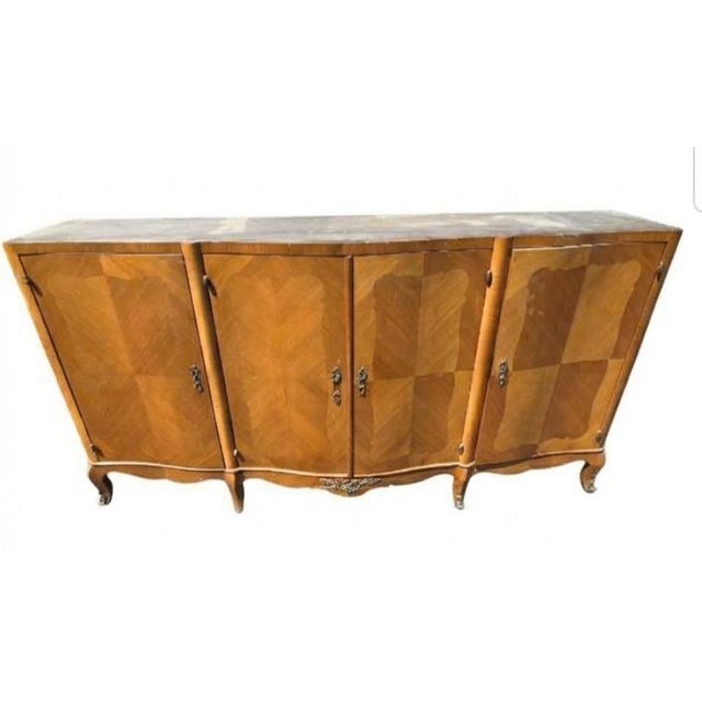 It features classic French provincial cabriole legs, a scalloped apron, decorative brass escutcheons, and distinctive...