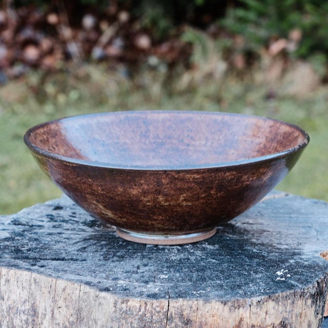 Large centerpiece bowl, wheel-thrown from dark stoneware and hand-painted with "Oolong Gloss Shino" glaze. Brand: Hiraeth...