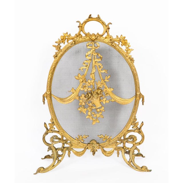 This is a superb and very decorative French Rococo revival brass and mesh fire-screen, circa 1880 in date. The oval-shaped...