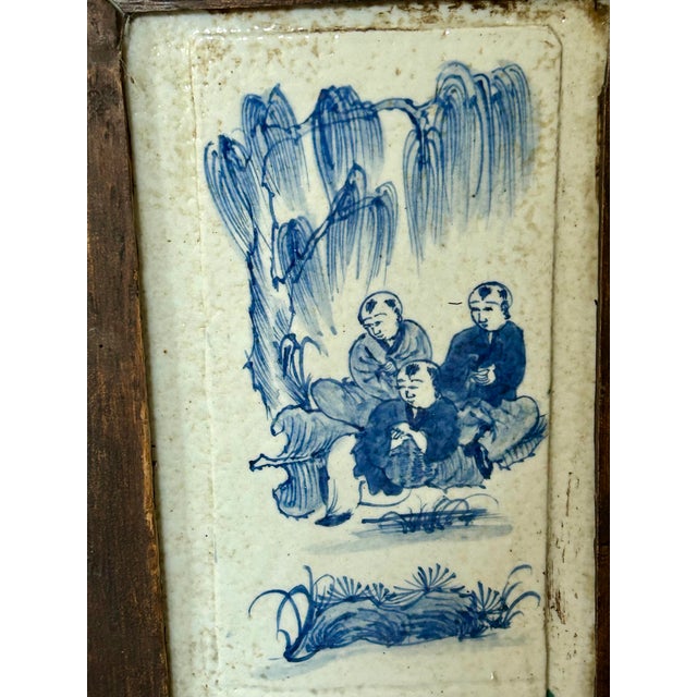 Pair of hanging panels each with five blue and white hand painted Chinese tiles that have been placed in wooden frames....
