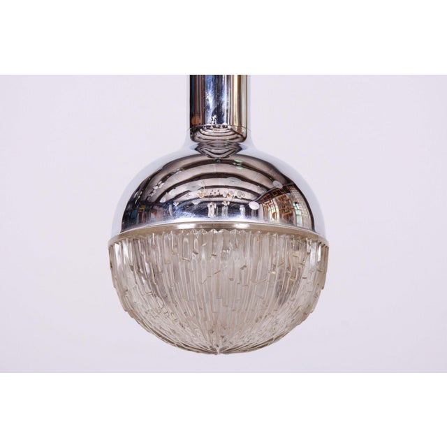 This stylish and visually captivating pendant chandelier, originating from the 1960s, represents an exceptionally...