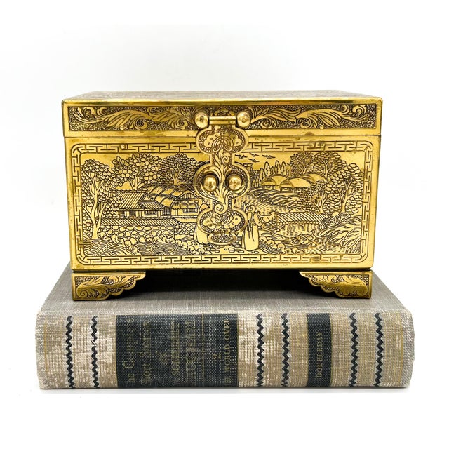 Brilliant, etched brass box with a laquered interior. The exterior features scenes from ancient China etched into the...