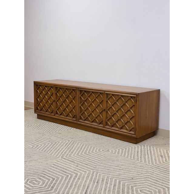 This handsome vintage Drexel Collage mid-century modern low console is a refined and distinctive living room or dining...
