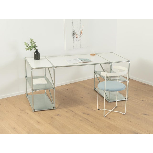 Classic desk from System 180 from the 1980s. High-quality frame made of stainless steel tubes with sheet metal shelves and...