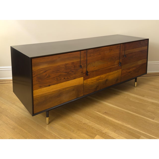BDDW Lake Credenza Designed by Tyler Hays Graphite lacquer exterior / Claro walnut front Hand-carved ebony handles...