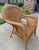 Offering a delightful pair of well made vintage club chairs made of wicker with a rattan strip overlay in an interesting...