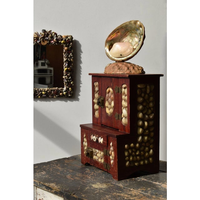 Antique Folk Art Coquillage Tabletop Cabinet, Circa Early 20th Century. Constructed from salvaged pine crates (with areas...