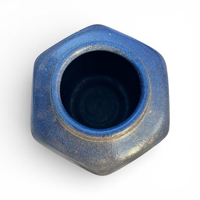 A handsome petite studio pottery vase of octagonal faceted form with raised rim. Glazed in an earthy blue. Signed by the...