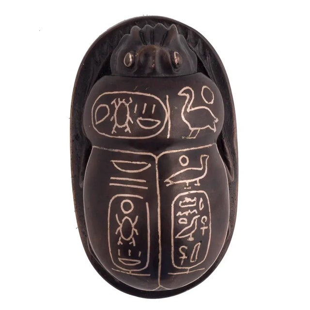 An early 20th century silver inlaid bronze scarab, probably European. The bronze scarab in a deep rich patina, inlaid with...