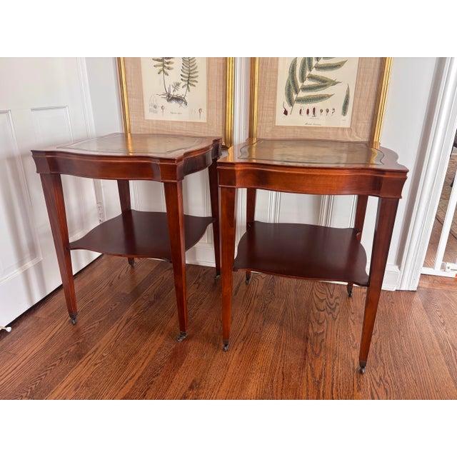Absolutely beautiful pair of vintage early to mid 20th century letter top end tables with original leather tops and brass...
