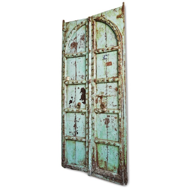 Antique Indian doors showcasing the soulful craftsmanship of traditional subcontinental architecture, likely dating to the...
