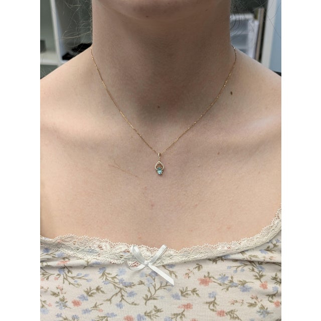 This elegant pendant features a 0.44-carat oval Afghan tourmaline, prized for its vibrant color and clarity. Set in a...