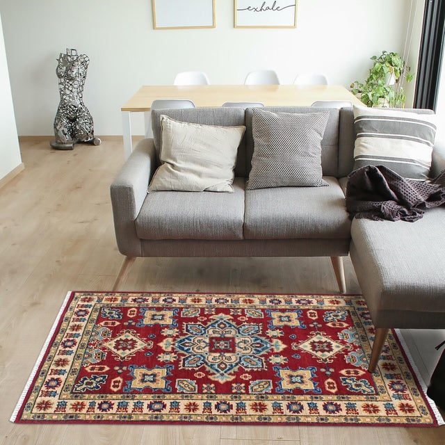 Enhance your home with this exquisite hand-knotted Kazak rug, crafted from fine hand-spun wool and dyed with all-natural...