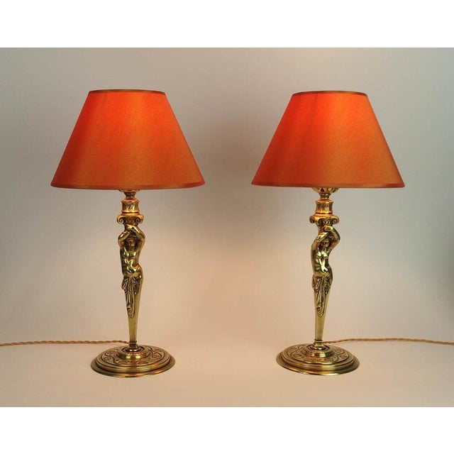 Pair of lamps representing Atlanteans, base decorated with garlands of ivy leaves. 19th century, France European Plug (up...