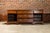 An English oak long buffet from the 19th century with five drawers, two doors, brass hardware and carved feet. Step back...