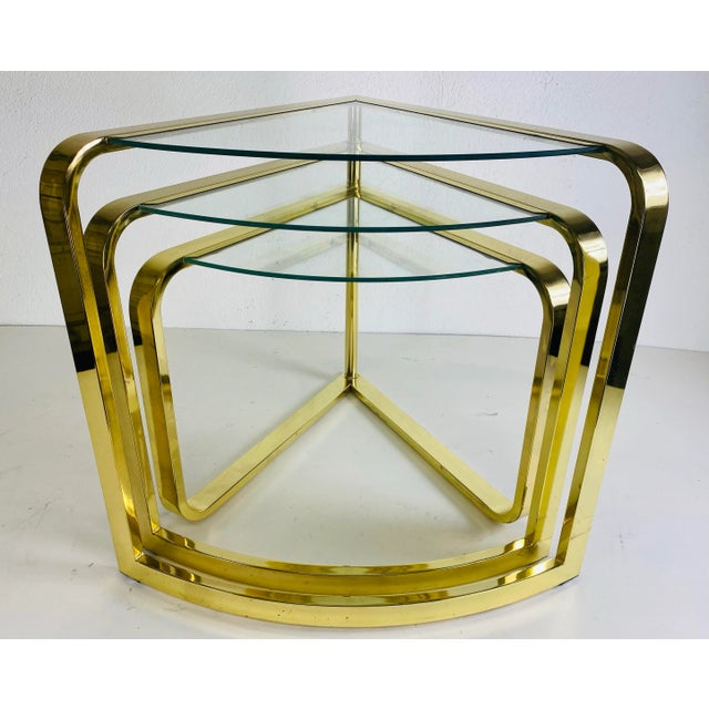This is a brass nesting table by design Institute of America. This unique nesting table fans out from a single pole on the...