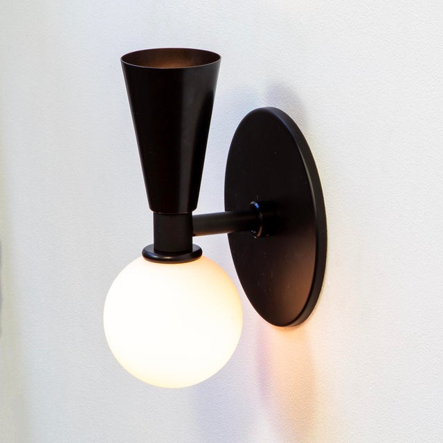 Cone and globe, in perfect balance. The Small Shapes Sconce is small-scale design with big energy.