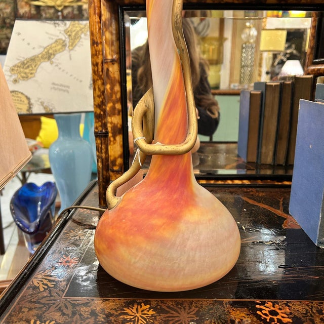 Art Nouveau style lamp with an orange design. Late 19th - early 20th century A delicate Art Nouveau period lamp crafted...