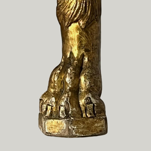 "Pair of ceremonial armchairs in carved and gilded wood. Fluted feet ending in lion's paws, richly carved crosspieces....