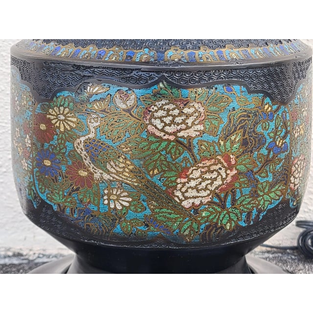 A gorgeous vintage Japanese Champleve table lamp in a two handled urn form, featuring colorful enamel images of long-...