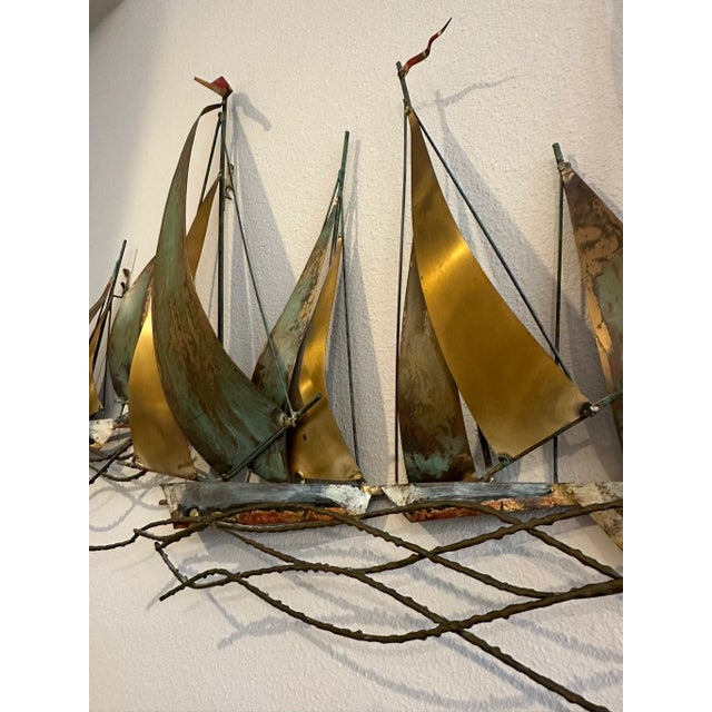 This Curtis Jere Sailboat Wall Sculpture is a hand wrought sculpture in copper brass and metal with verdigris. The...