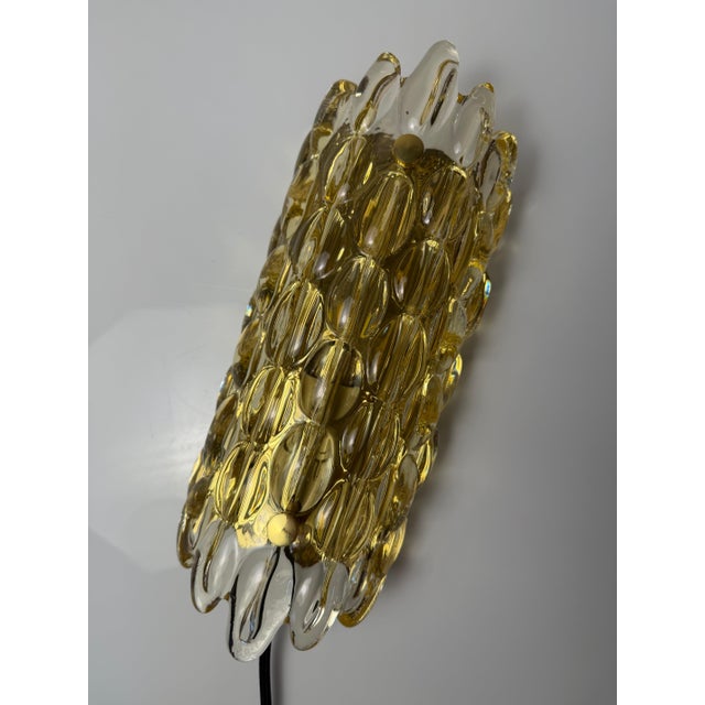 A captivating piece of Swedish glass art: This magnificent wall lamp from the 1960s was designed by renowned designer Carl...