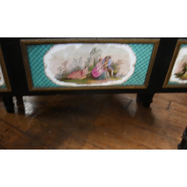 Victorian ebonised two door display cabinet with porcelain columns and pictorial plaques Again the colour interplay...