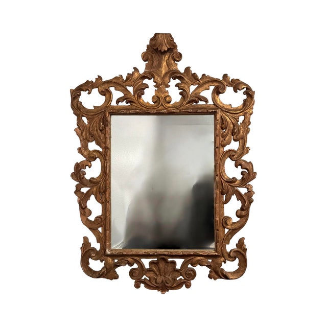 I BLURRED OUT THE IMAGE OF ME TAKING THE PHOTO IN THE MIRROR. A striking and highly decorative carved giltwood wall mirror...