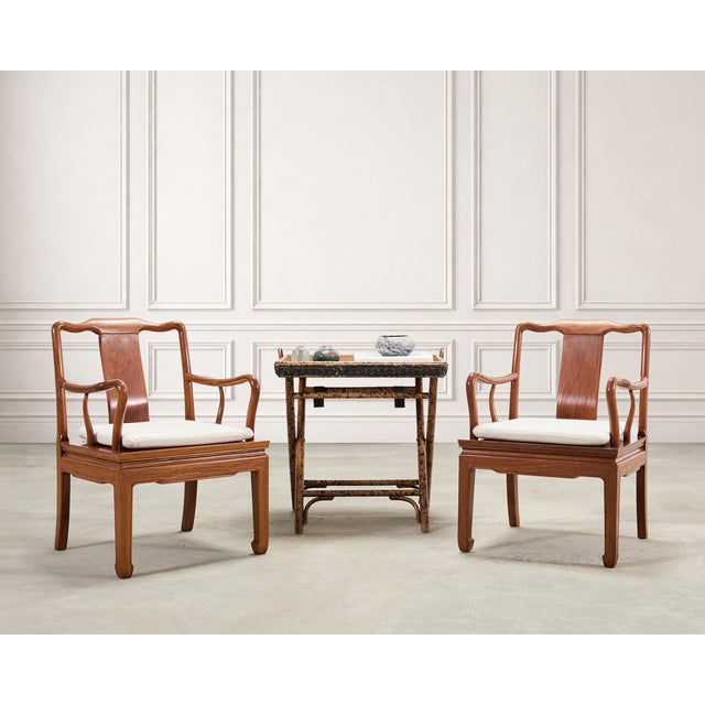 A handsome pair of Chinese armchairs executed in a Ming Dynasty-style Southern Official's Hat form constructed from...