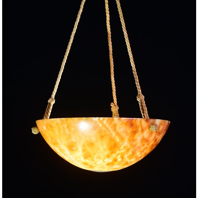 Antique brown alabaster hanging chandelier in Art Deco style, circa 1940s. A unique piece in orange alabaster, beautifully...