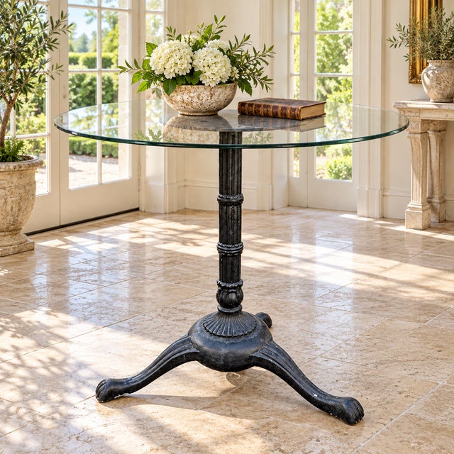 A sculptural vintage cast-iron plant stand or display pedestal in the Neoclassical Revival taste. The piece features a...